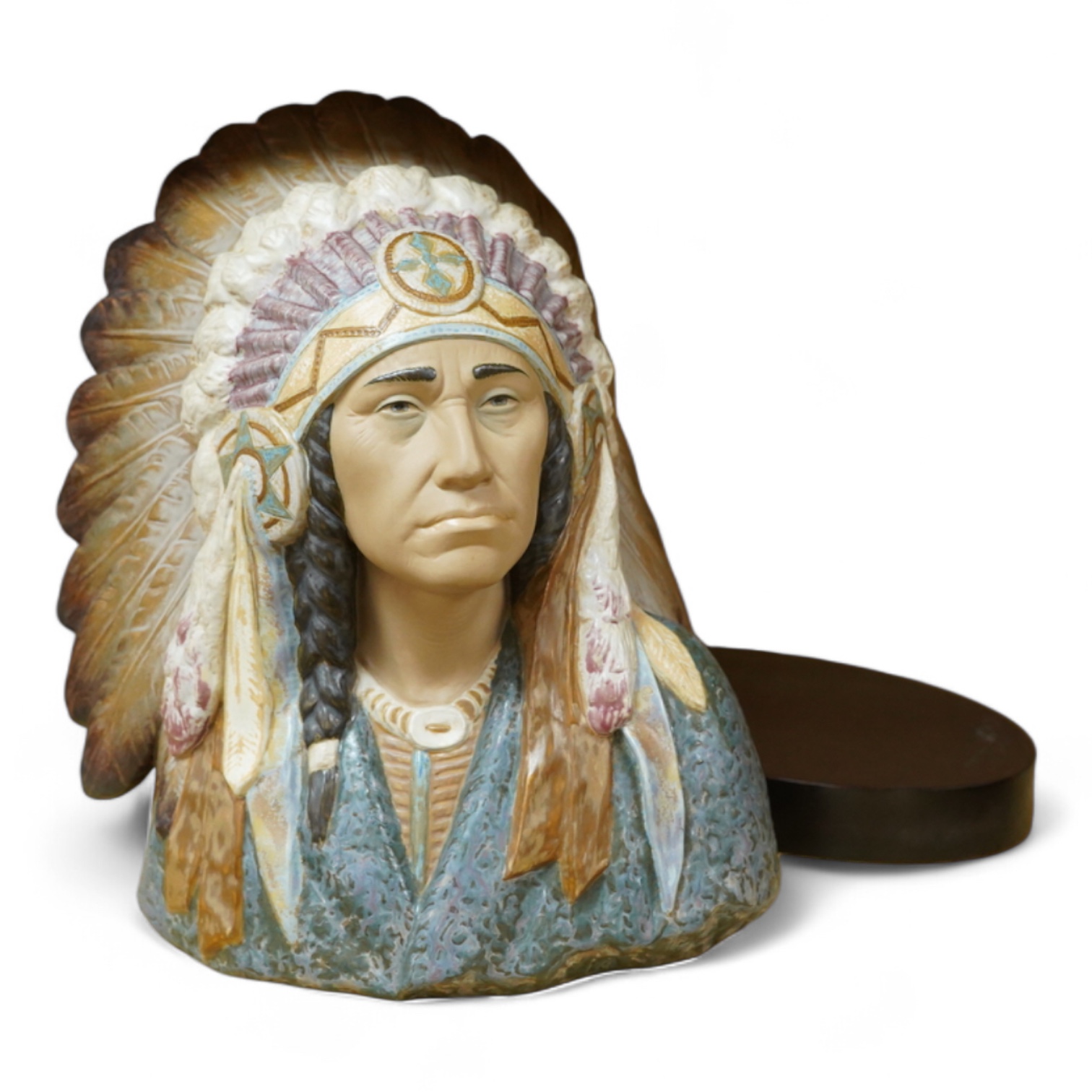 A Lladro bust of a native America chief with feather tribal headdress, 29cm high. (Bust on stand)